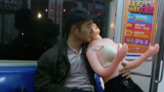 Man Rides the Subway. With a Blow-Up Doll.